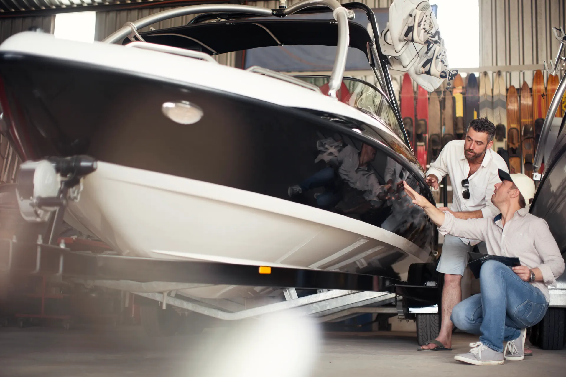 two-men-inspecting-a-boat-in-a-workshop-2024-07-03-02-32-58-utc two-men-inspecting-a-boat-in-a-workshop-2024-07-03-02-32-58-utc